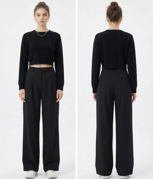 Person wearing black high-waisted trousers and a black crop top on a white background