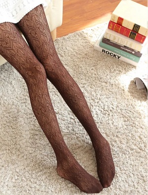 Brown patterned tights worn by a person on a carpeted floor with books and a chair in the background.