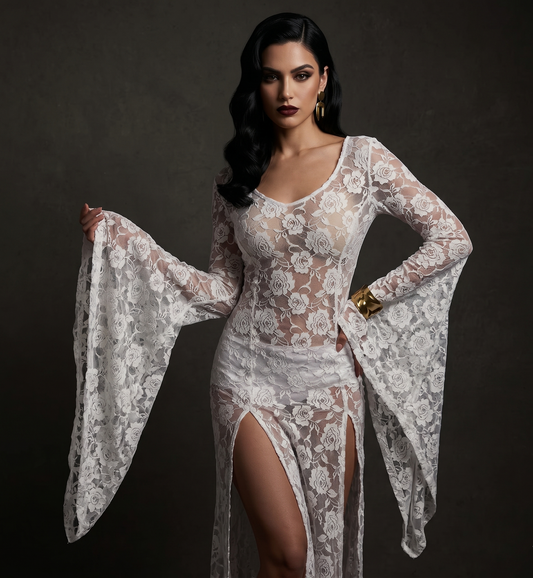 Woman wearing a white lace dress against a dark background