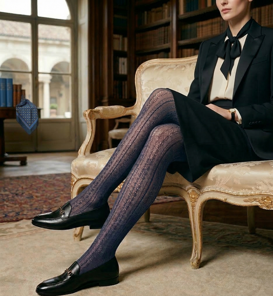 Woman in formal attire with patterned tights sitting on a chair in a room with bookshelves.