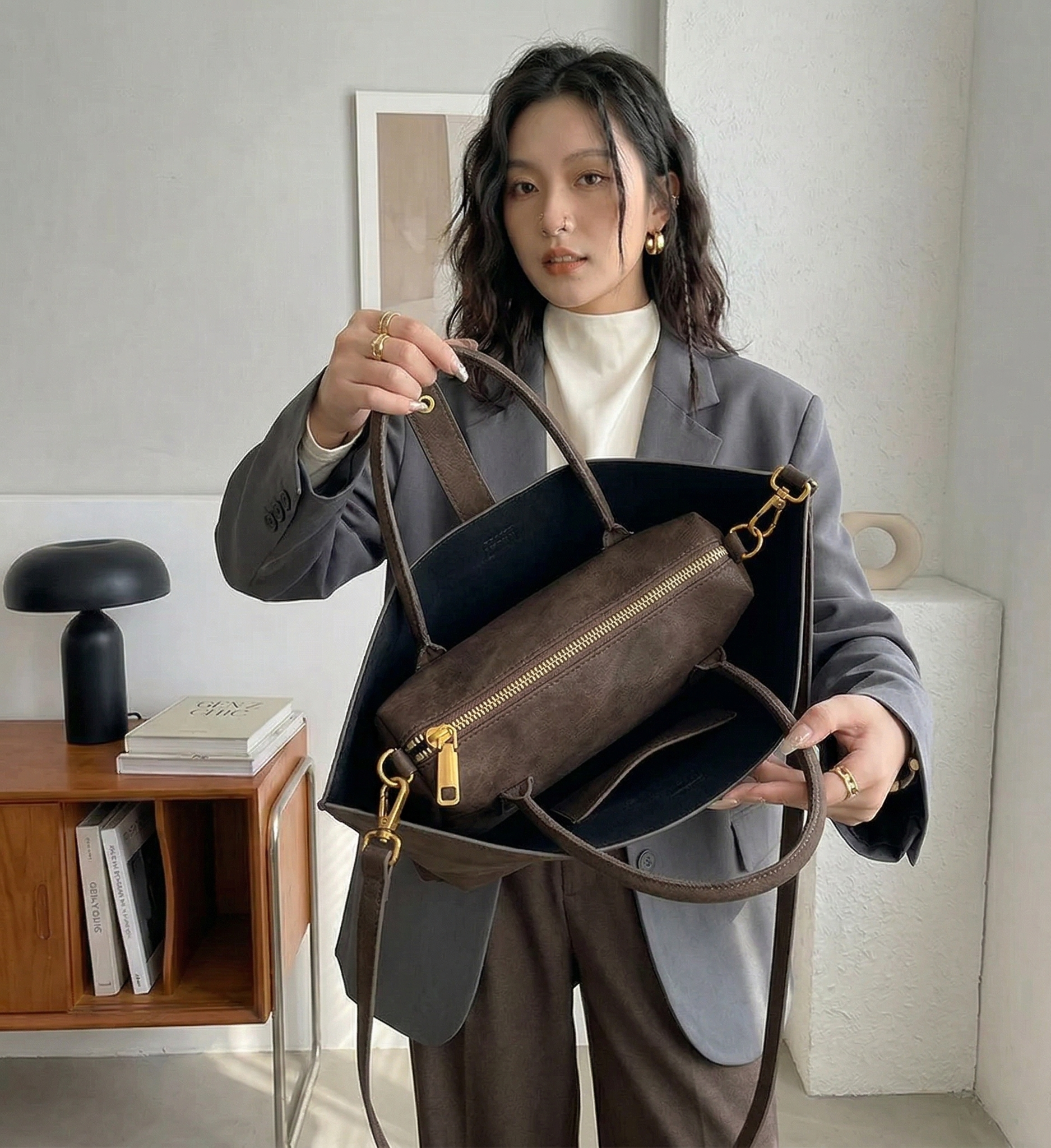Woman holding a brown leather handbag indoors