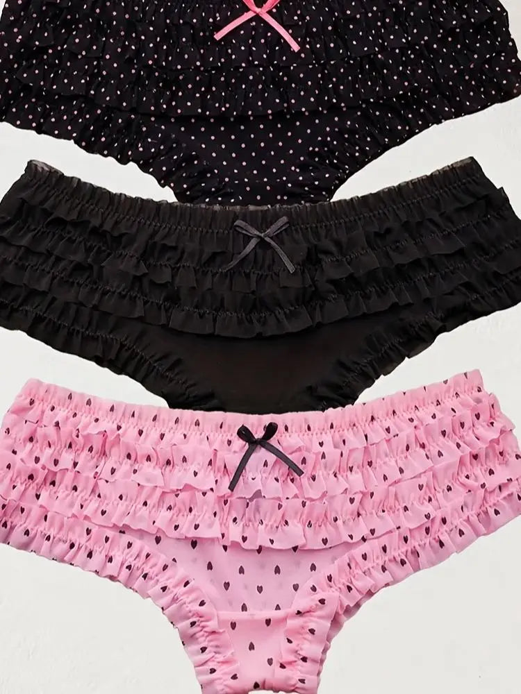 Two pairs of black and pink ruffled underwear on a white background
