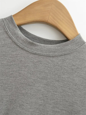 Gray sweatshirt on a wooden hanger against a white background