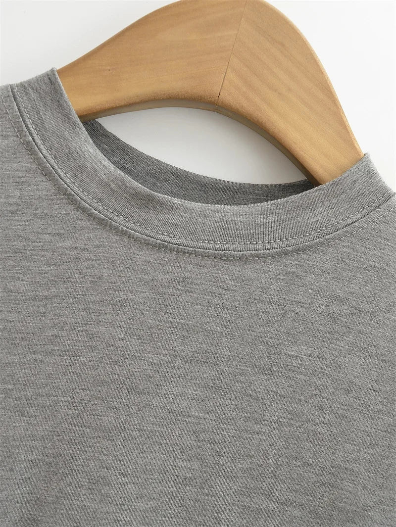 Gray sweatshirt on a wooden hanger against a white background
