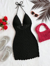 Black crochet dress with pink bag, sunglasses, and sandals on a white background